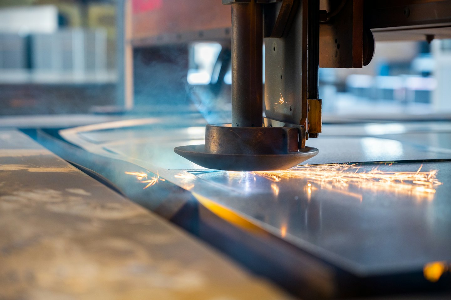 Laser cutting machine precisely cutting metal with bright sparks.