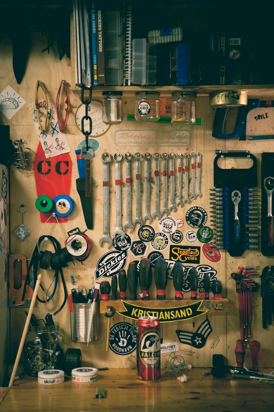 Workbench with tools, parts, and a Falcon beer can.
